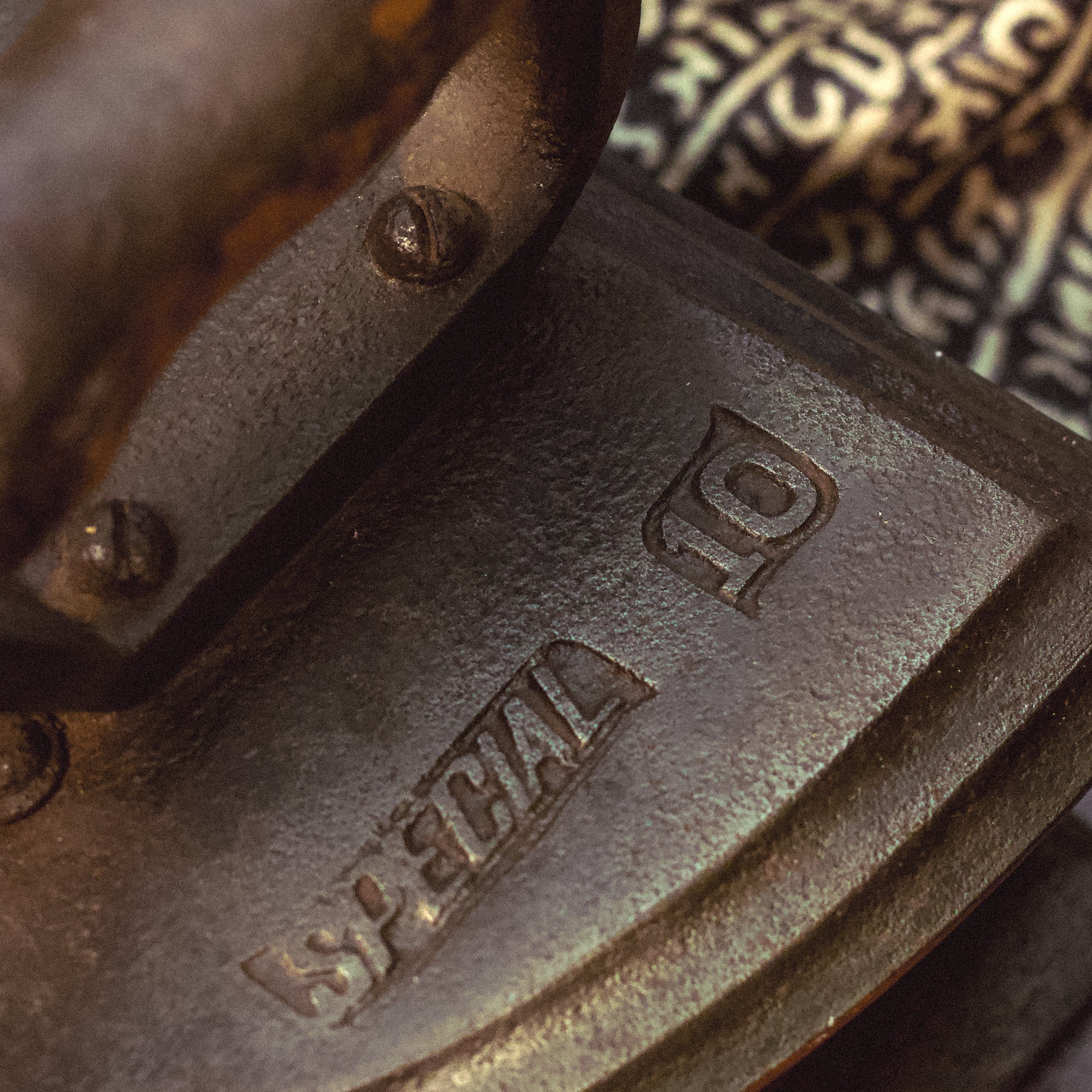 Close-up of a metal object with 'Special Q' branding.