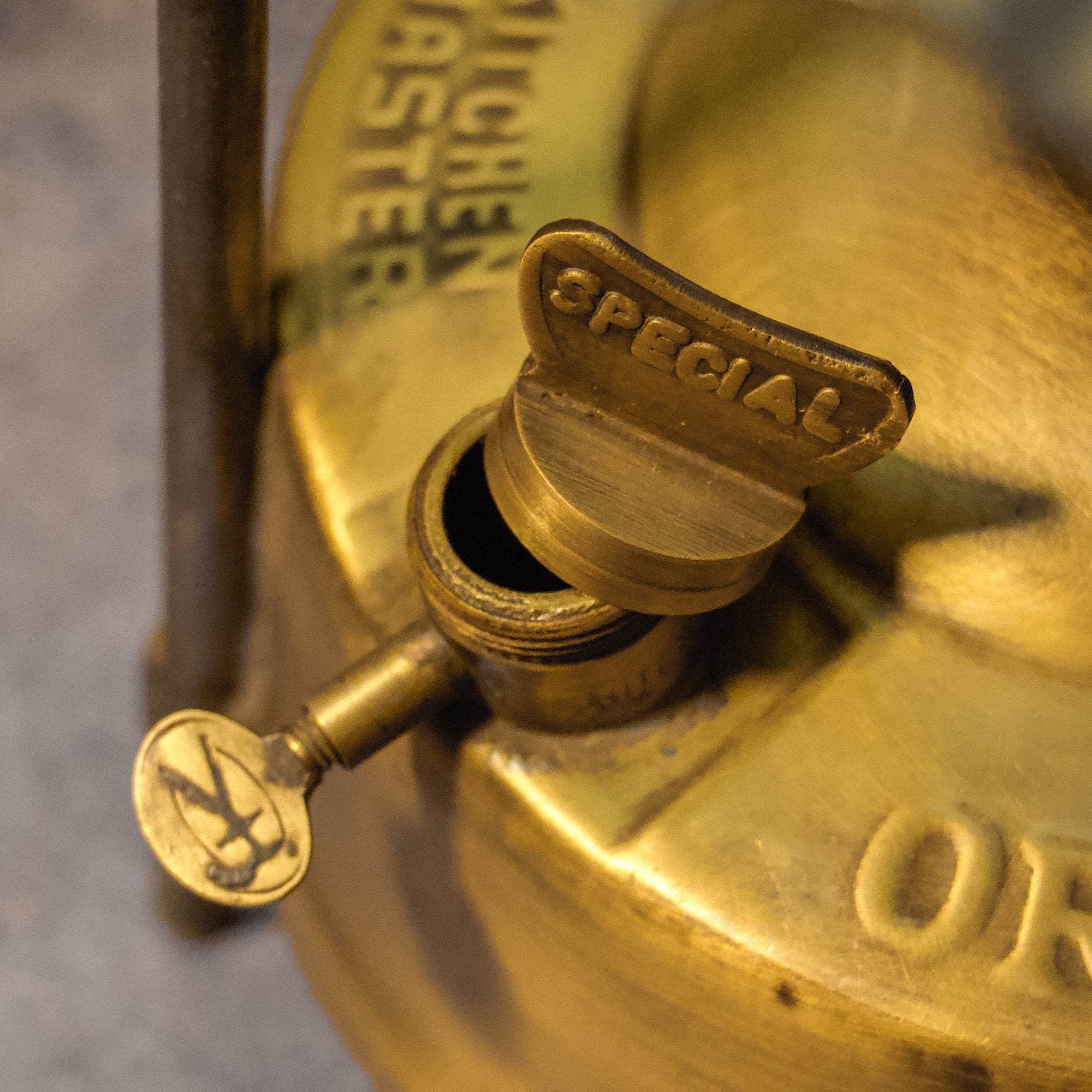 Close-up of a brass valve with 'Special' label on a blurred background