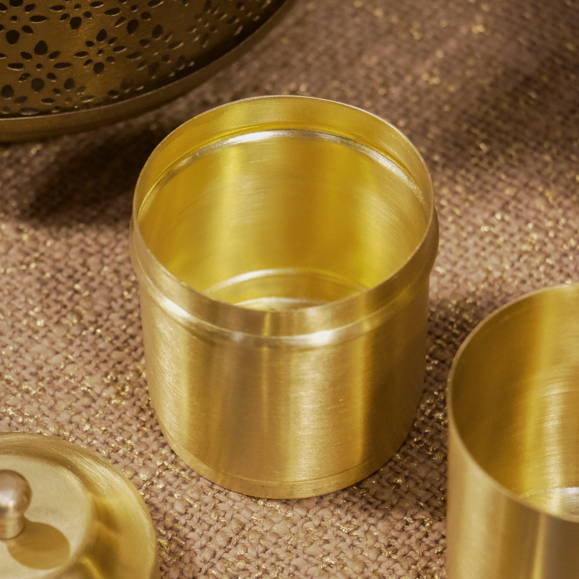 Gold metal cups on a textured brown surface