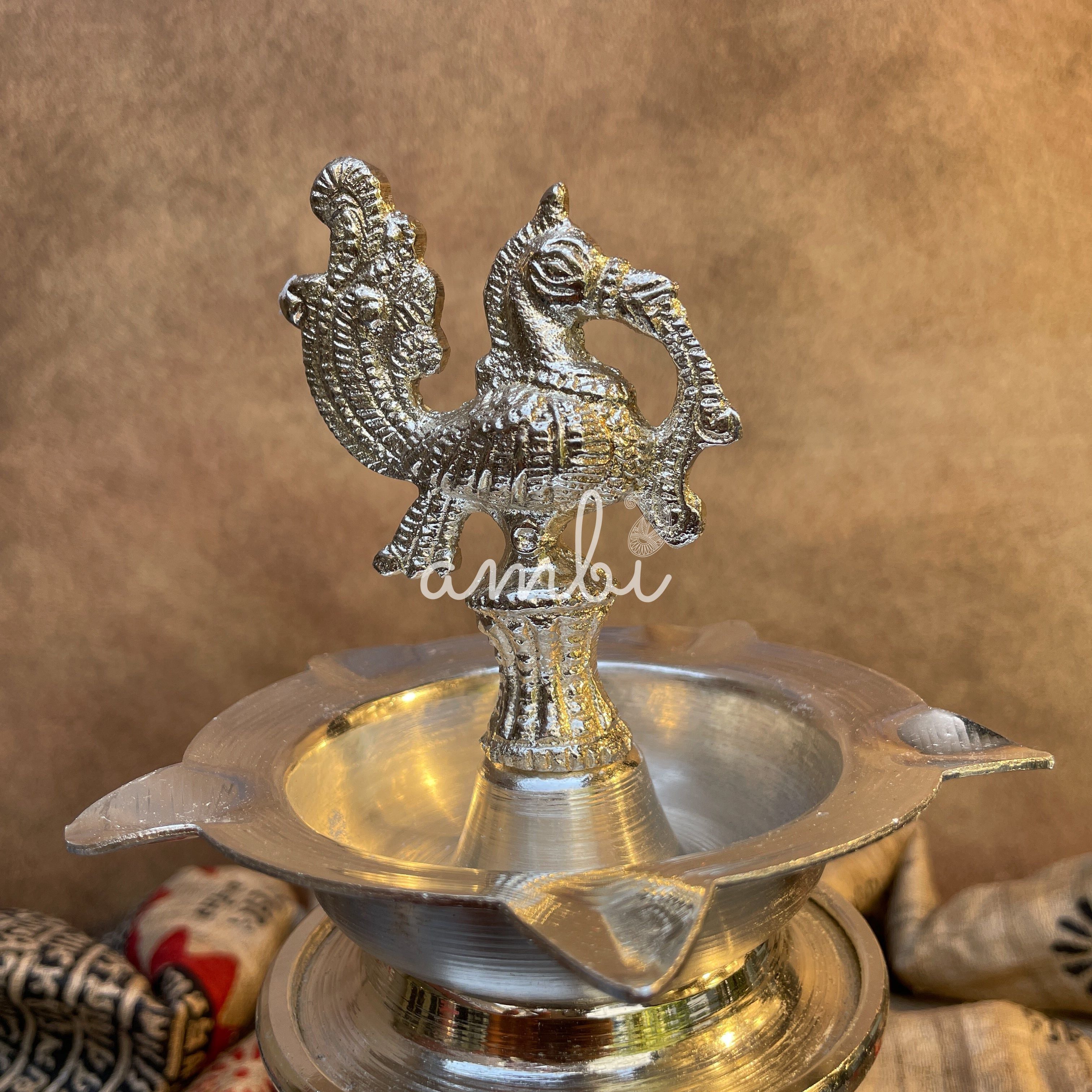 Ambi Silver Plated Peacock Oil Lamp – Decorative Pooja Diya with Ornate Base