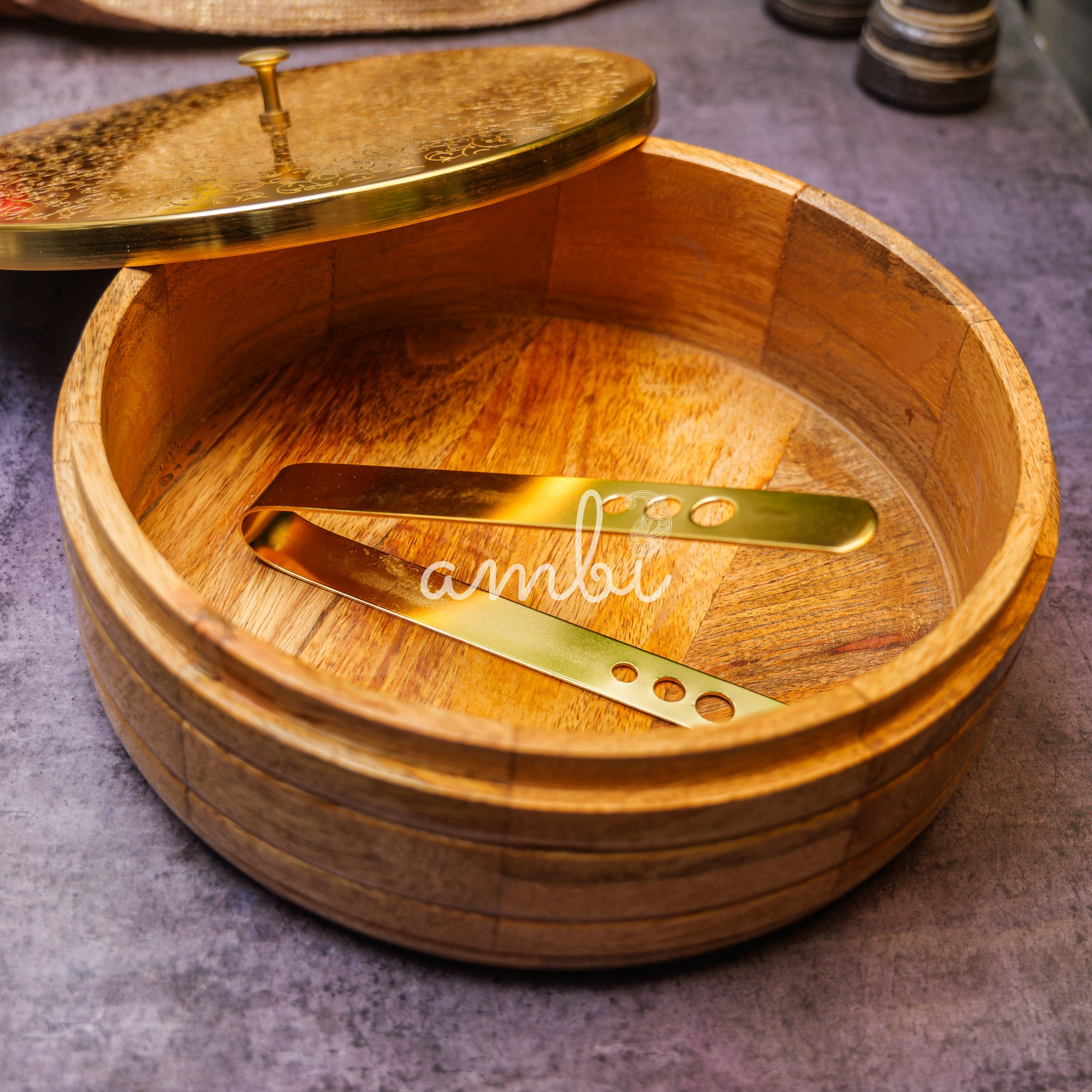 Intricately Etched Ambi Pure Brass Roti Box with Wooden Base and Tongs - 9 Inche