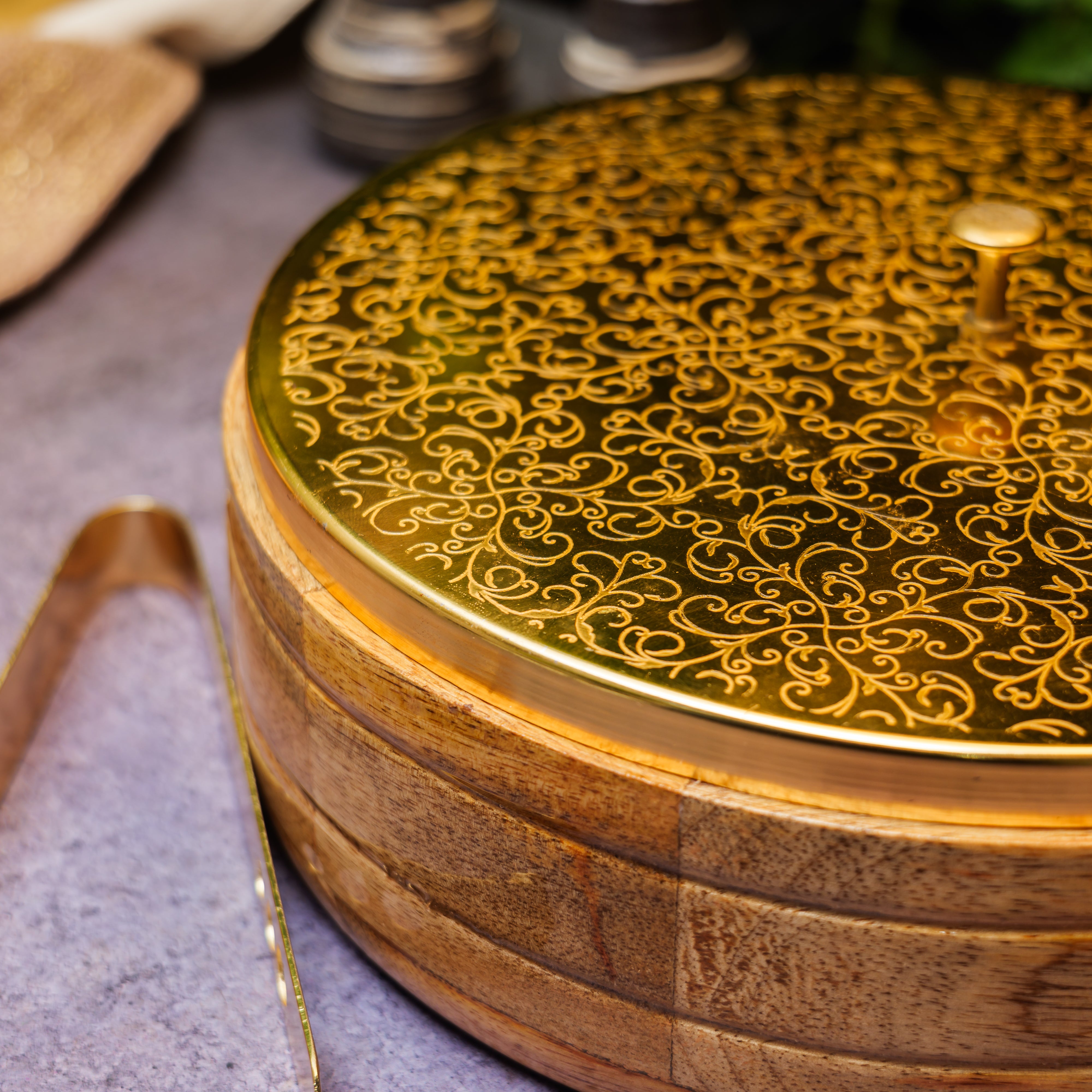 Intricately Etched Ambi Pure Brass Roti Box with Wooden Base and Tongs - 9 Inche