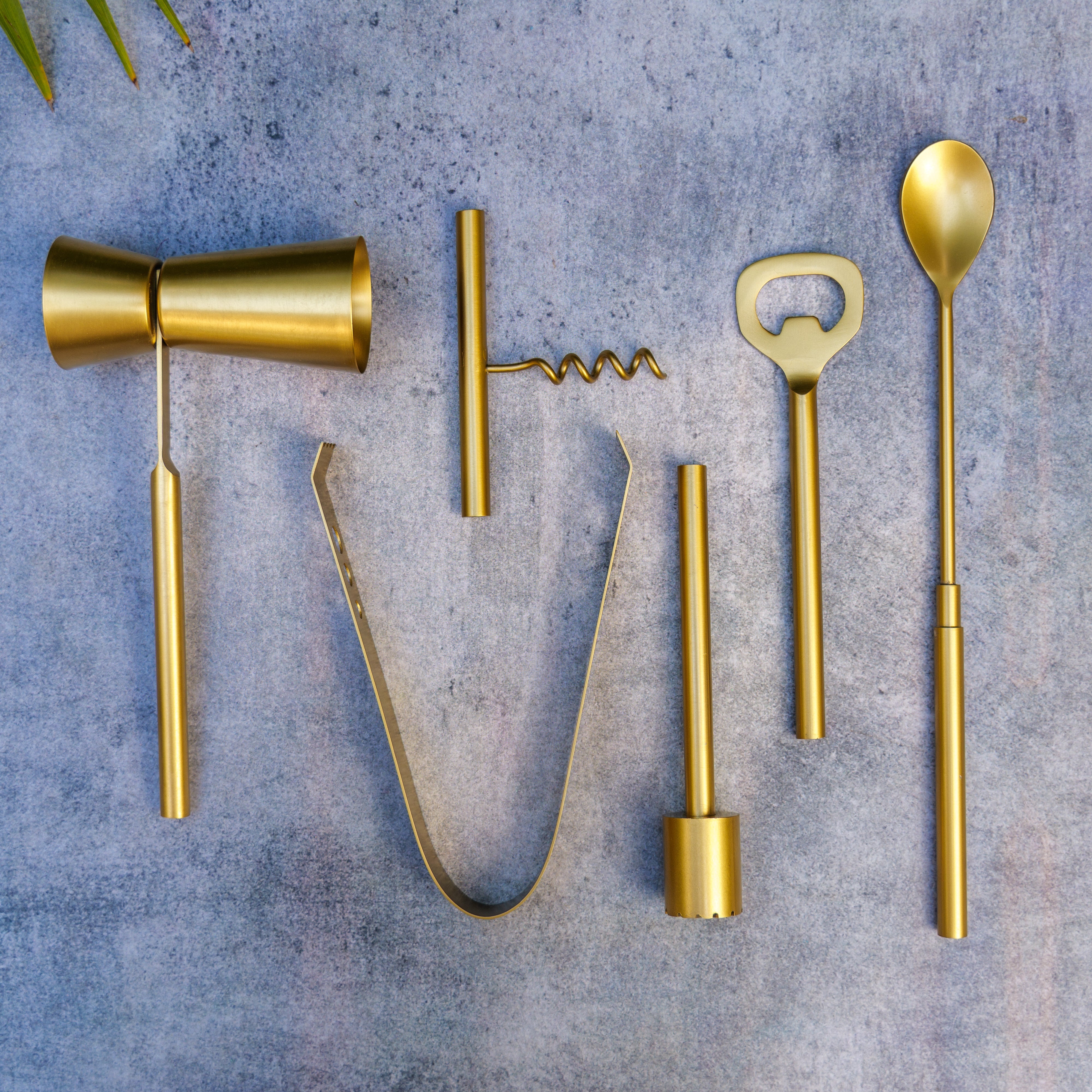 Set of gold bar tools on a textured gray surface
