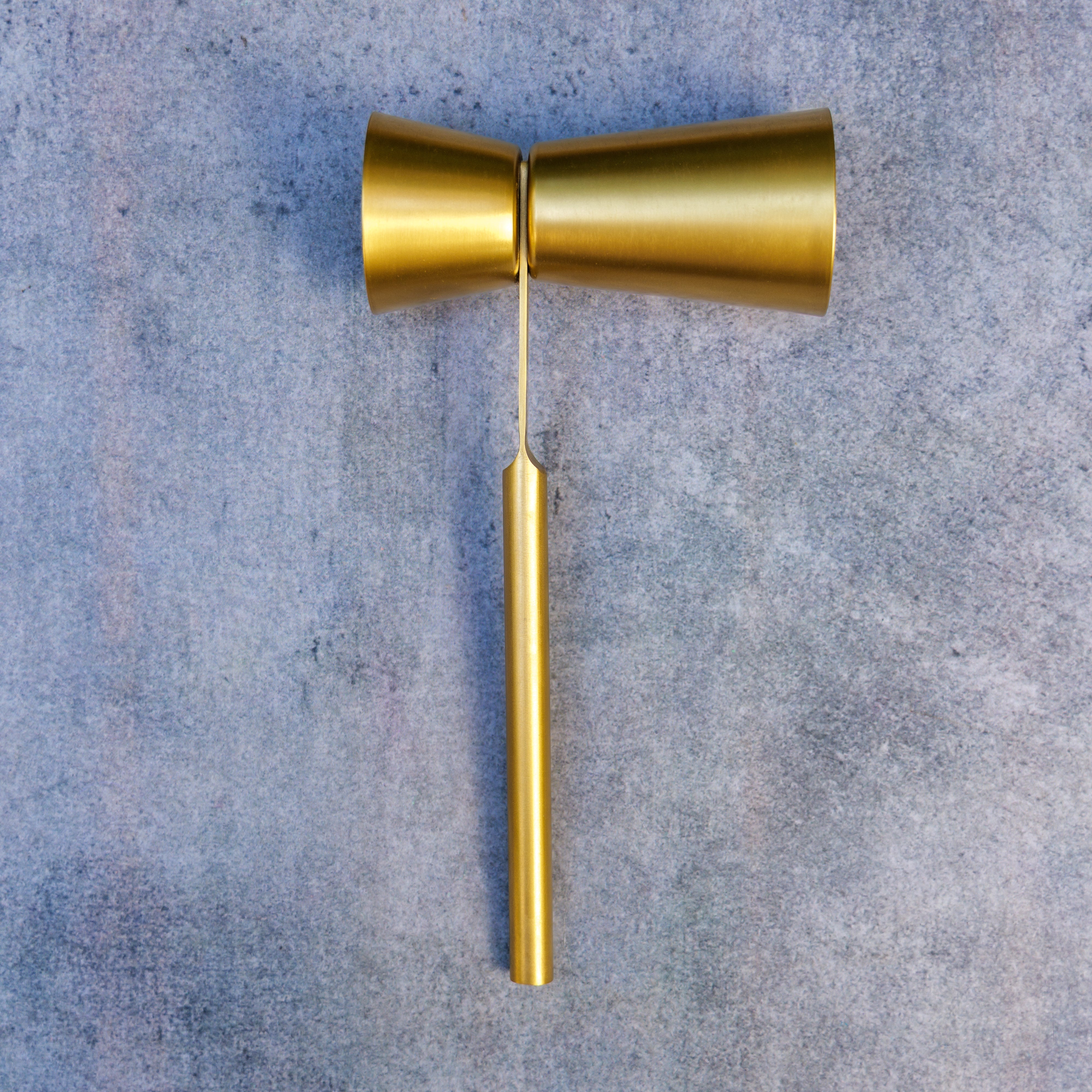 Gold door handle on a textured gray background