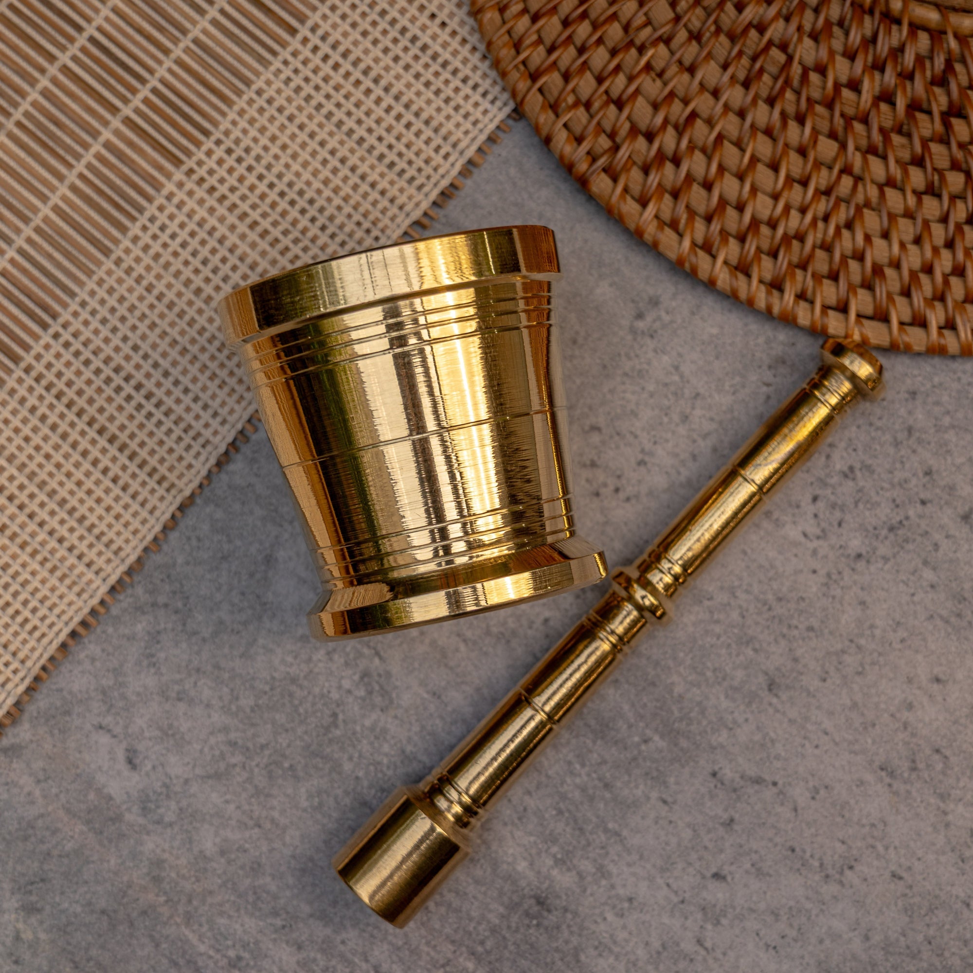 Gold metal cup and spoon on a textured surface