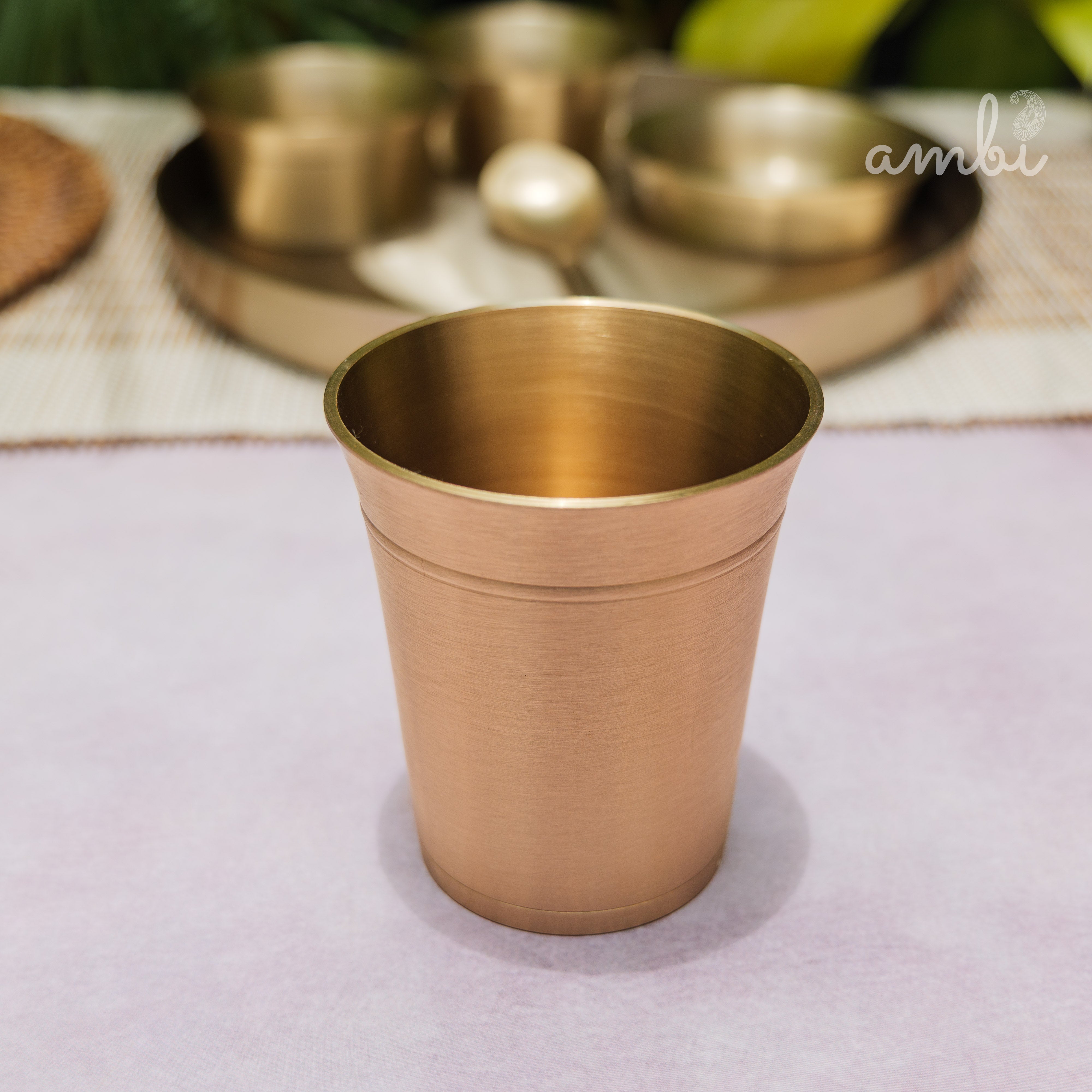 Gold cup on a white surface with 'Ambi Home' text overlay