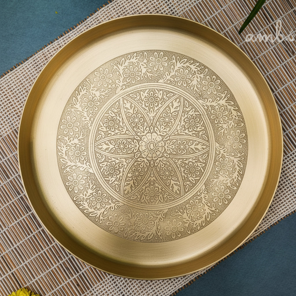 Decorative gold plate with intricate patterns on a textured surface