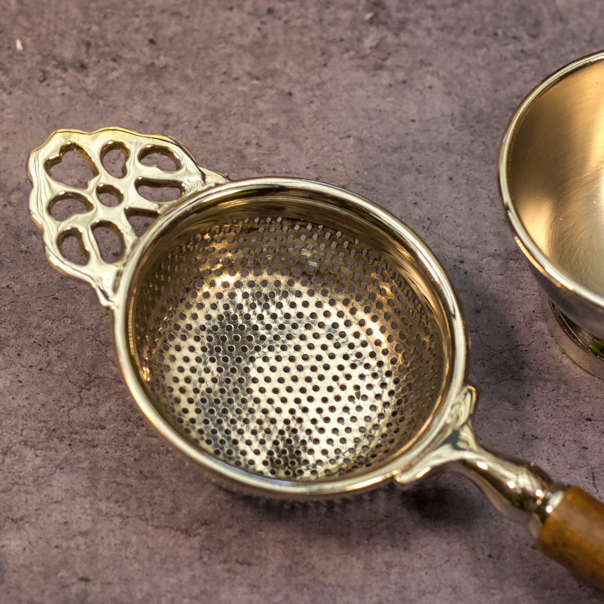 Pure Brass Punched Flower Medium Sized Tea Strainer - Gold Matte Finish With Wooden Handle and Resting pot